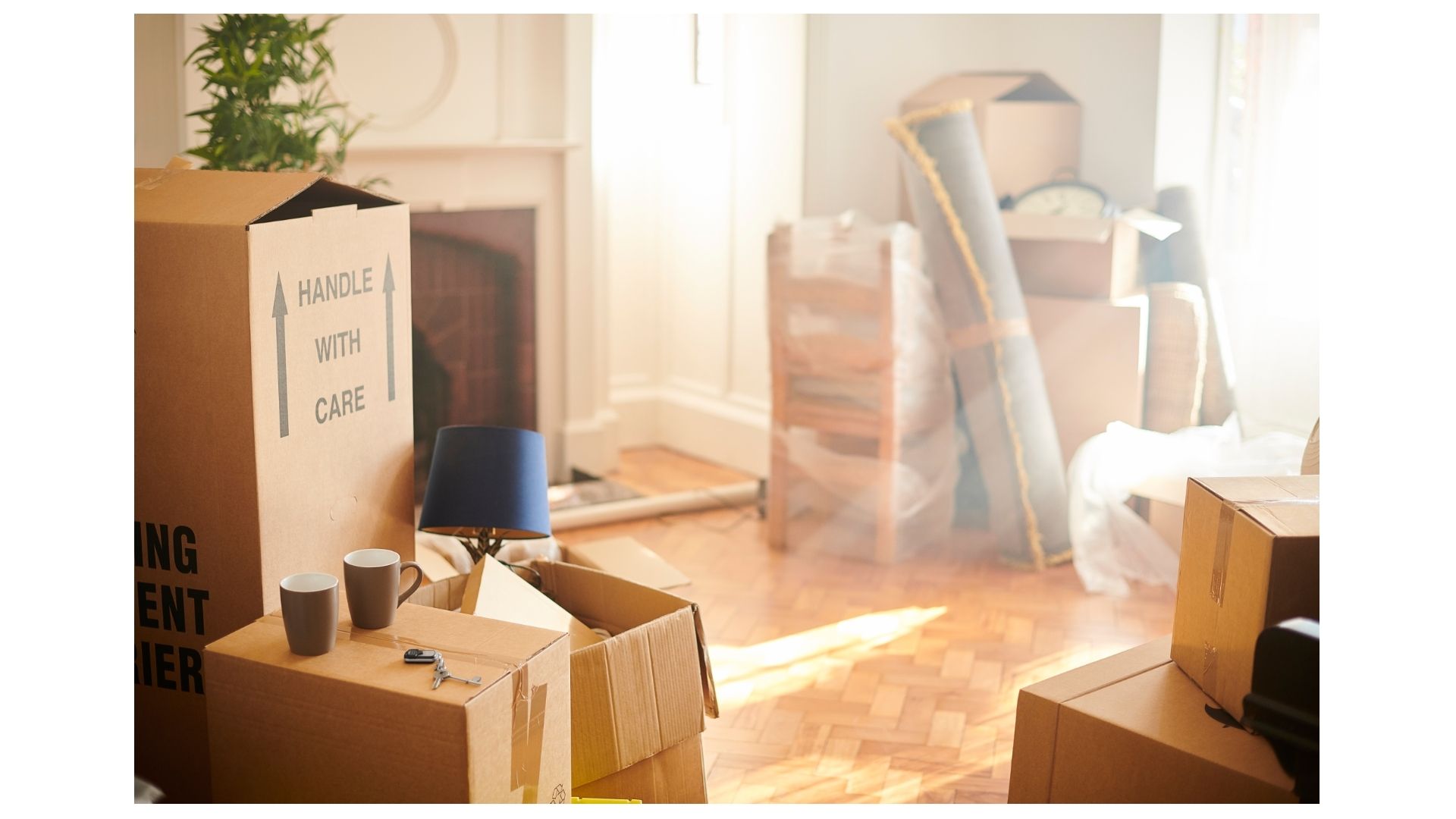 Stacked moving boxes labeled handle with care in a sunlit San Antonio home mid-move