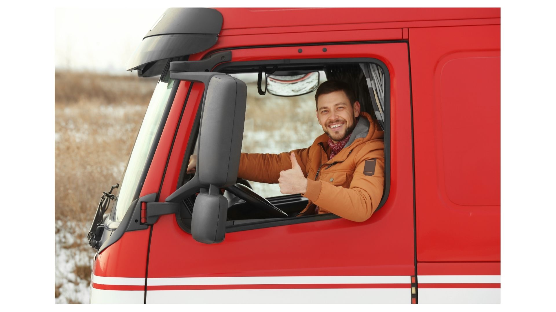 Smiling truck driver giving a thumbs up from the cab of a red moving truck