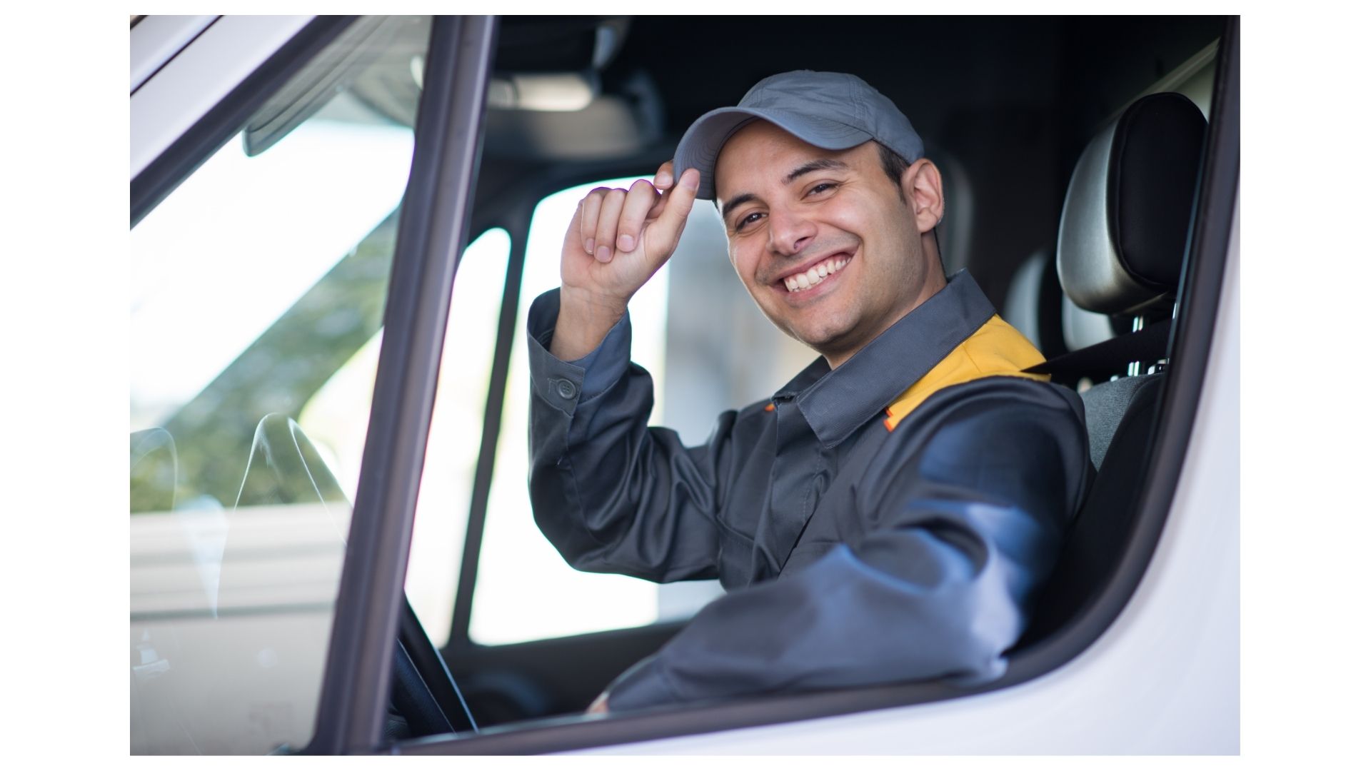 Friendly Half Price Movers driver tipping his cap and smiling from the cab of a moving truck