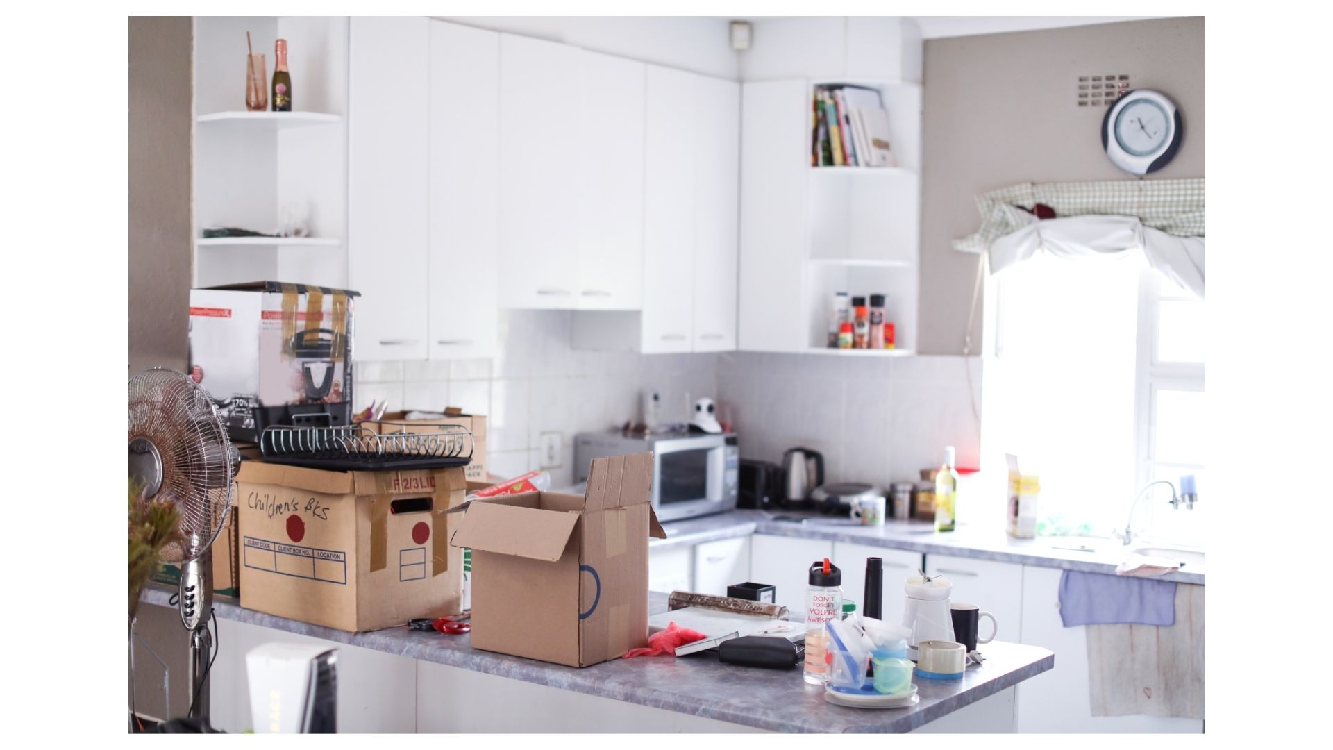 Kitchen mid-move with moving boxes packed and ready for full service movers in San Antonio