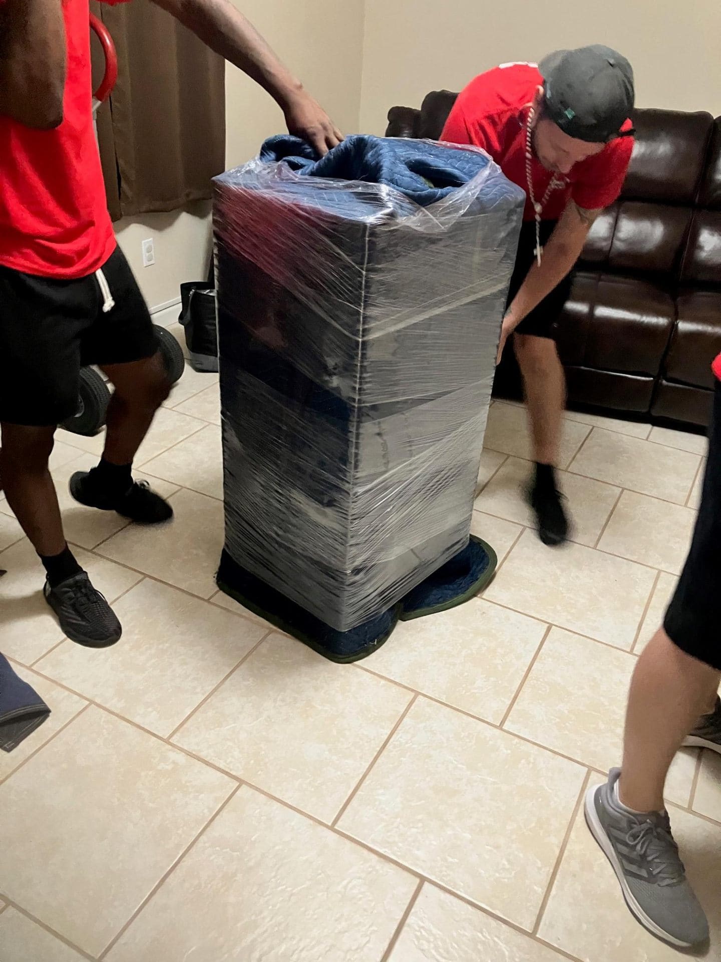 Half Price Movers crew wrapping a high-value item for secure transport