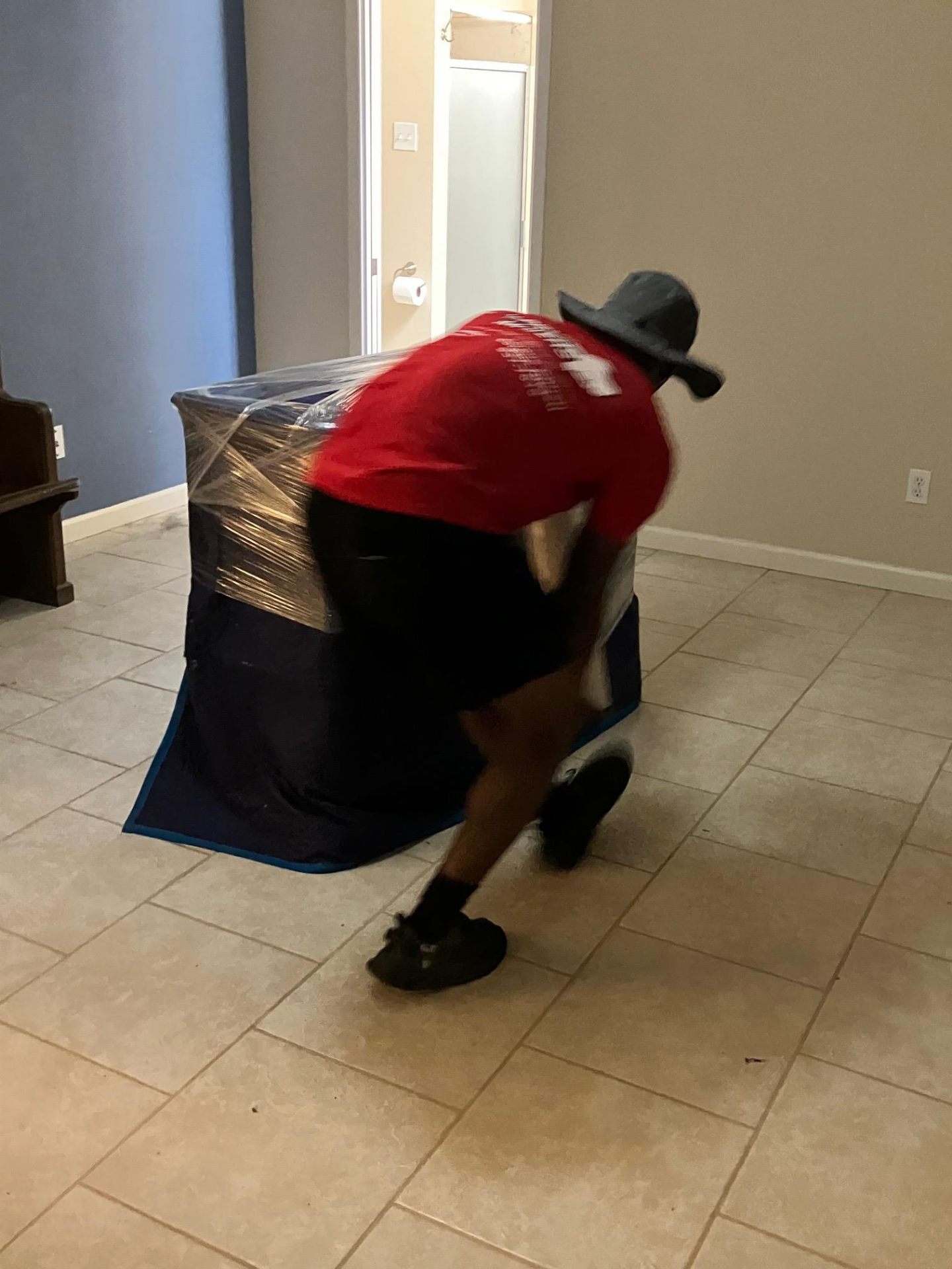 HPM crew member wrapping furniture with stretch wrap