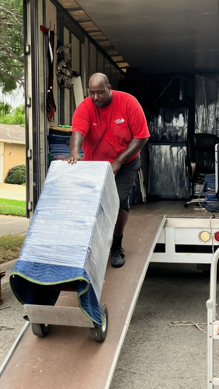 Half Price Movers crew carefully wrapping and crating a large item